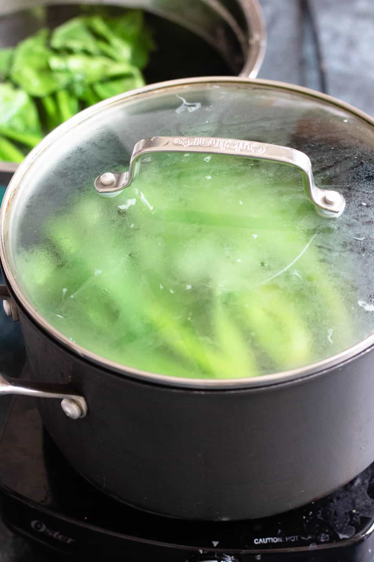 Cover on a pot of boiling water and yu choy inside. 