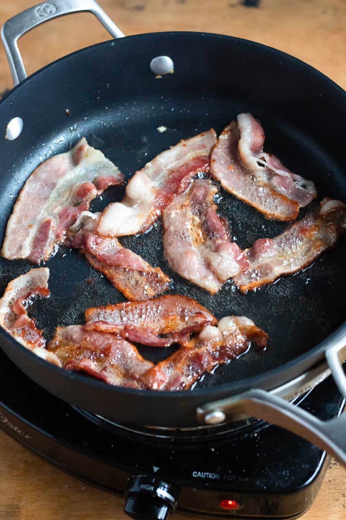 Bacon frying in a pan. 