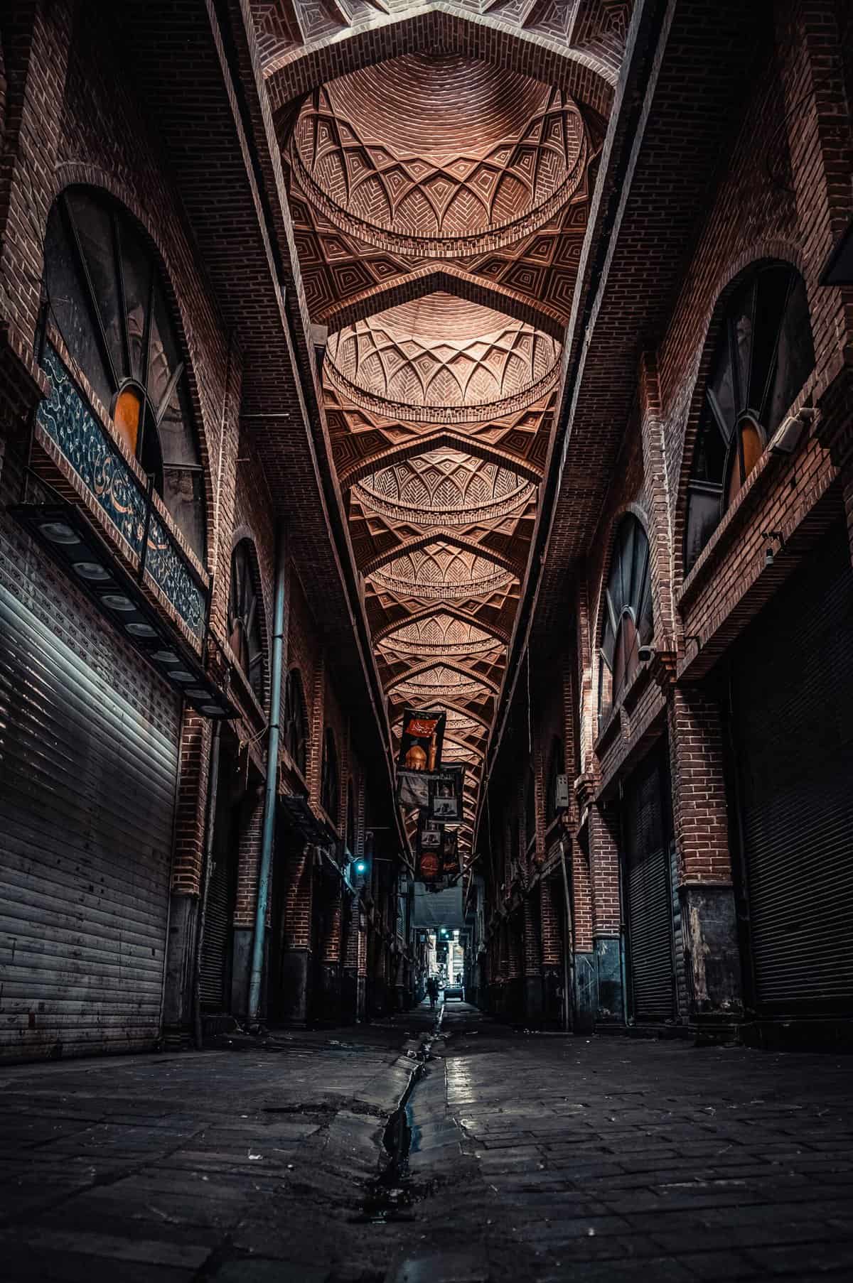 Dark alley with closed garage doors and banners hanging