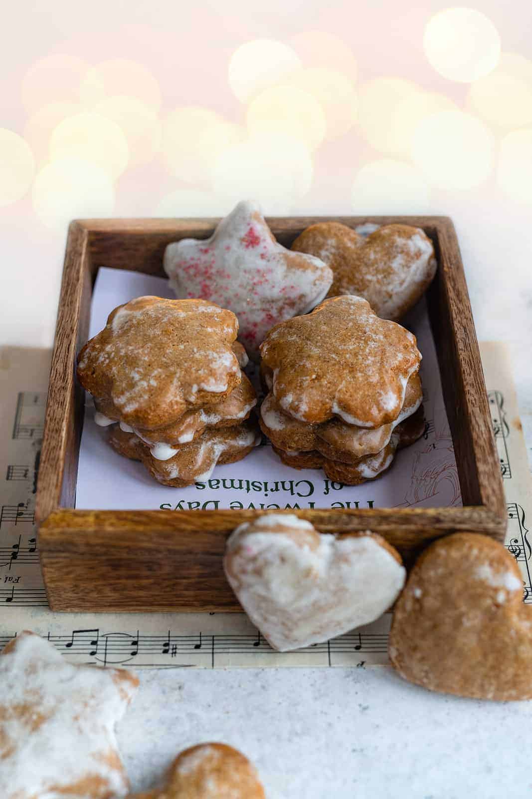 Star and heart shaped ginger cookies (lebkuchen) served in a wooden tray. 