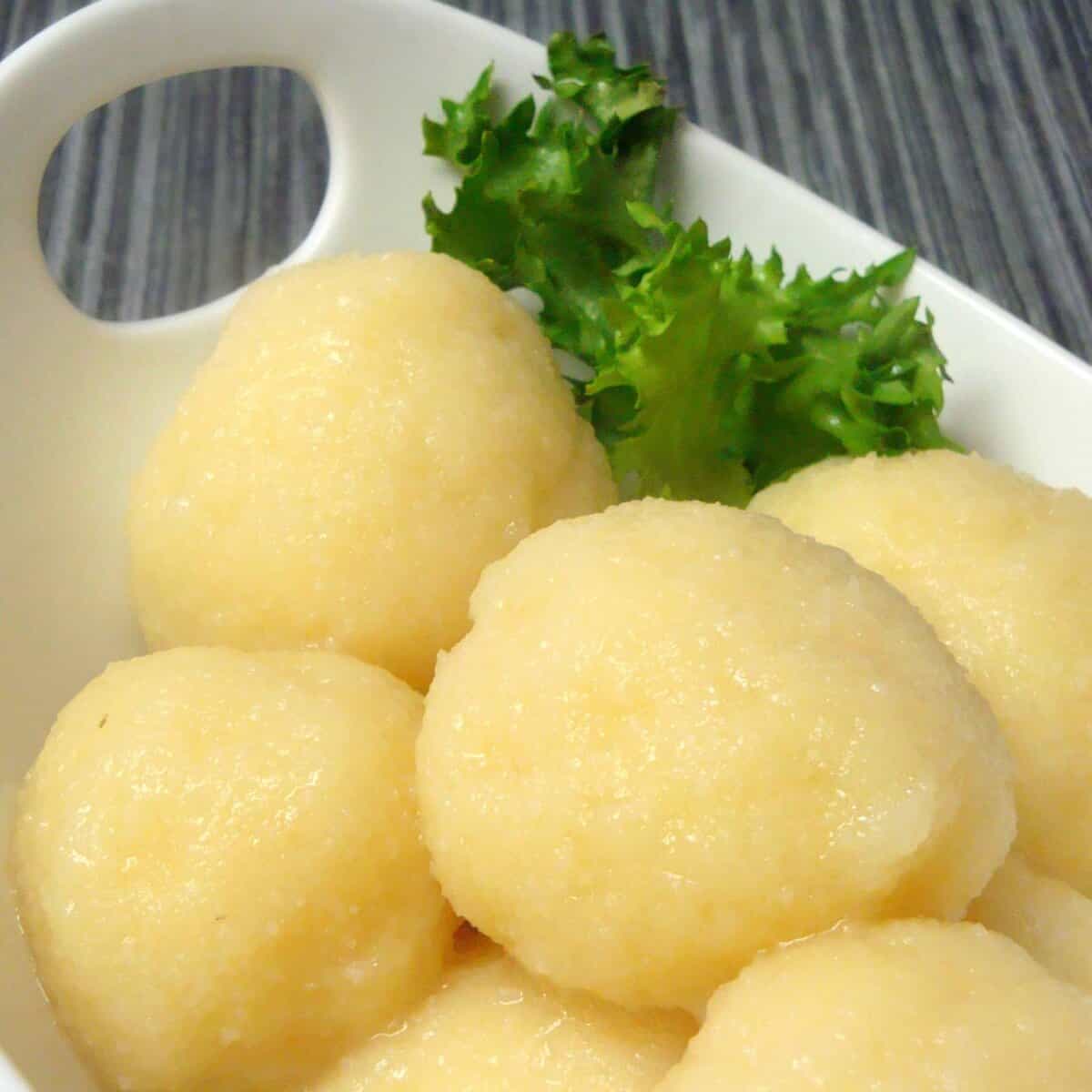 Potato Dumplings (Kartoffelklöße) served in a serving container. 