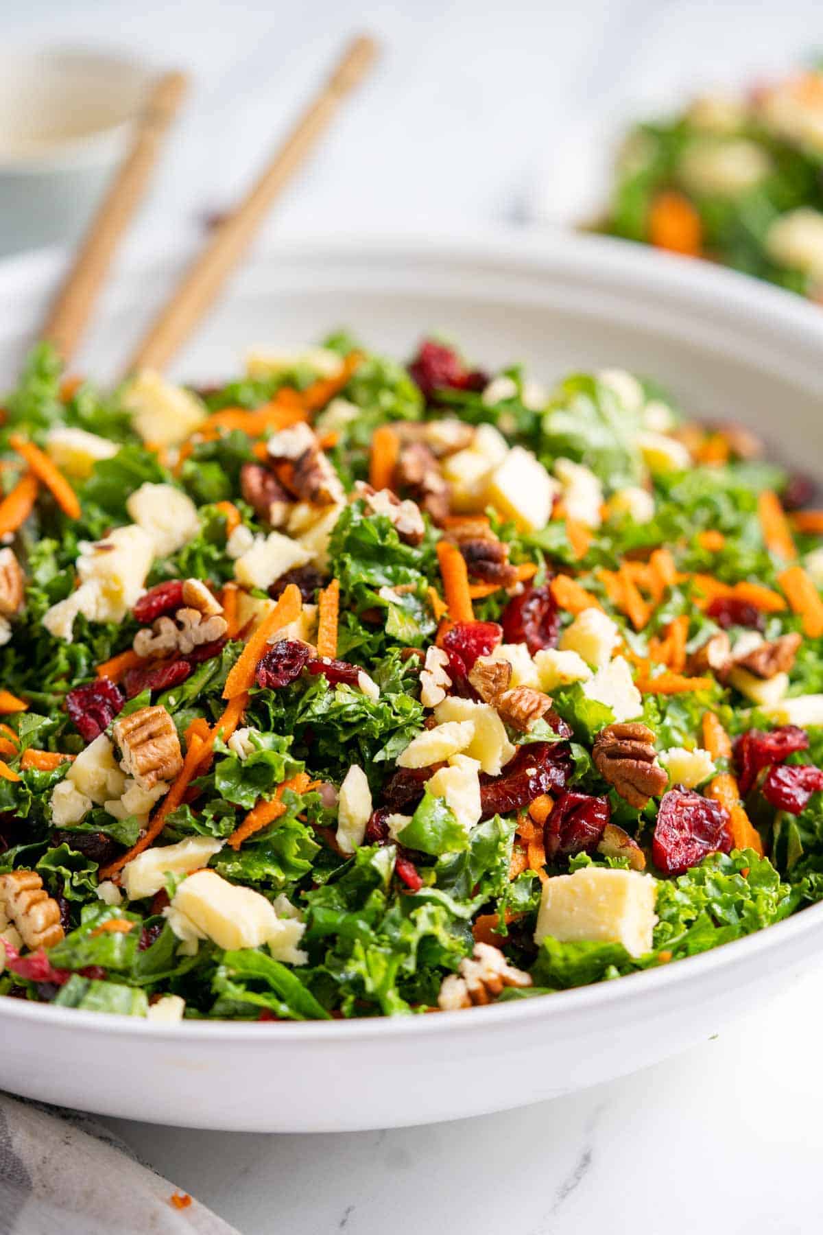 Kale salad with cranberries in a salad serving bowl. 
