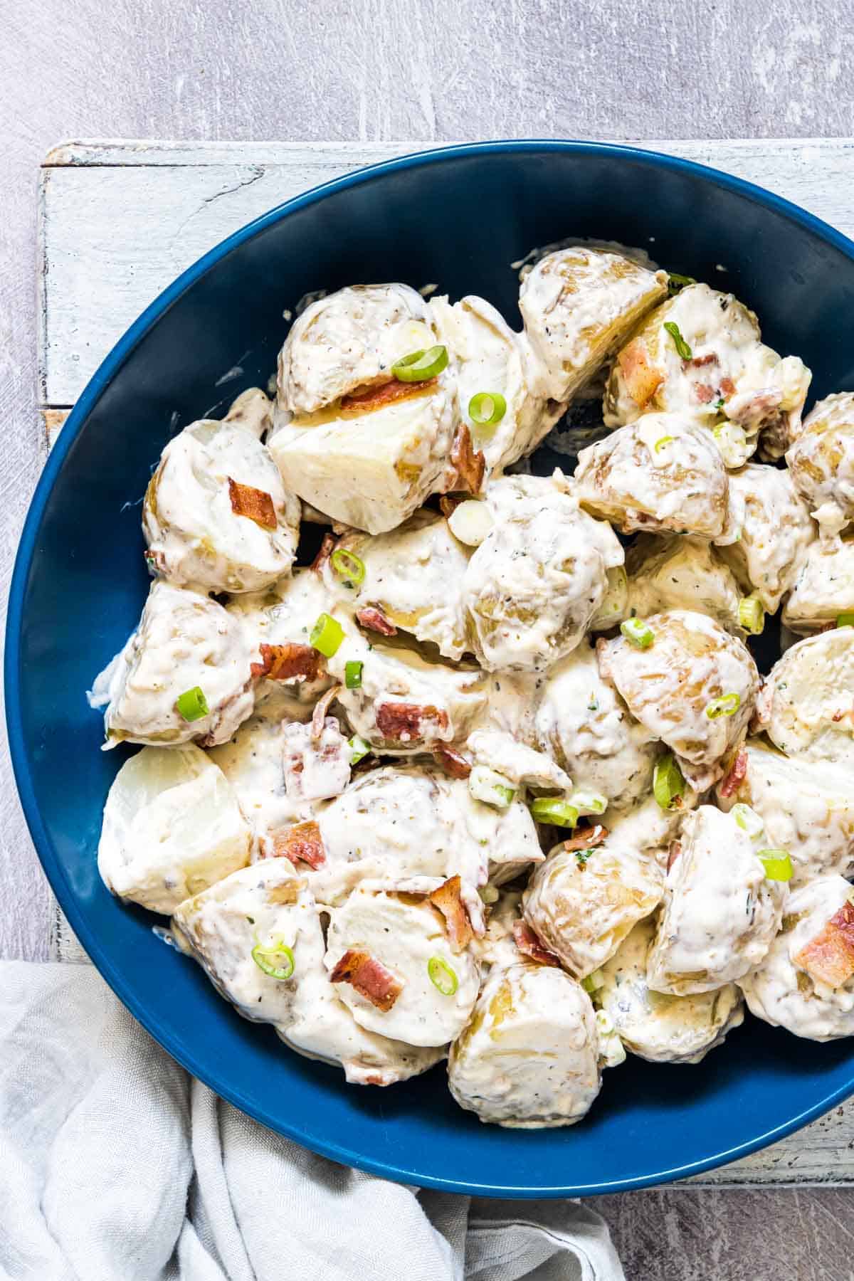 Loaded Ranch potato salad in a blue serving bowl. 
