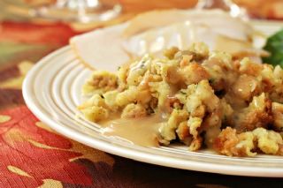 Apple sausage stuffing, a traditional German Christmas dinner, served on a plate next to turkey. 