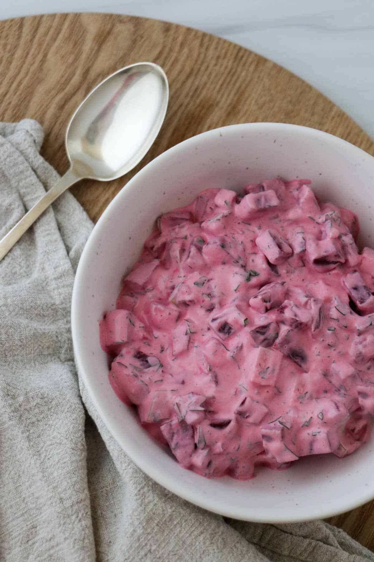 beetroot salad (rödbetssallad)in bowl with a spoon on the side. 