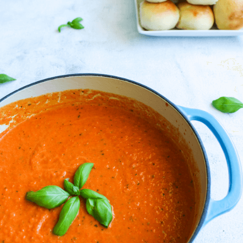 Tomato basil soup with a basil sprig on top. 