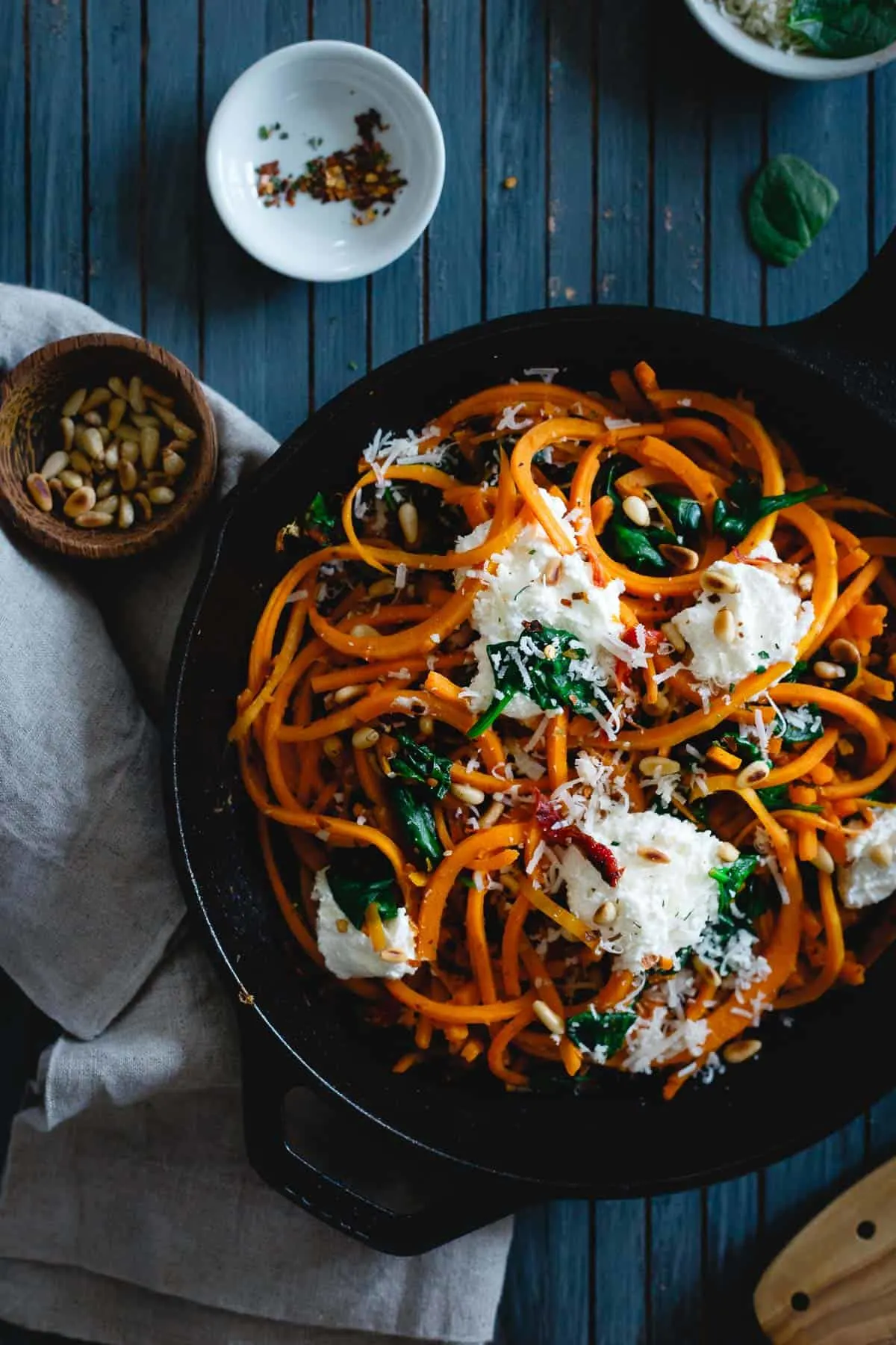 Garlicky butternut squash noodles with spinach and ricotta served over the top. 