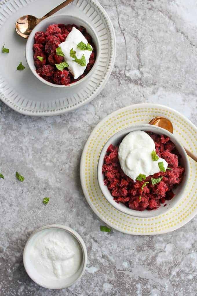 Two small dishes of berry granita with a dollop of ricotta over the top. 