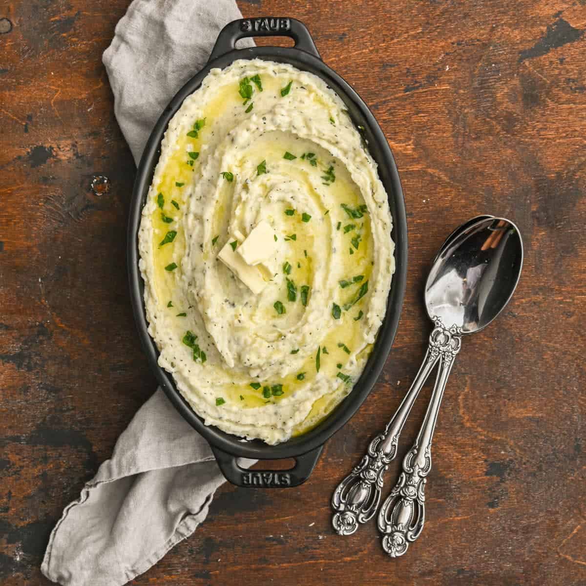 Creamy boursin mashed potatoes in an oval cast iron pan. 