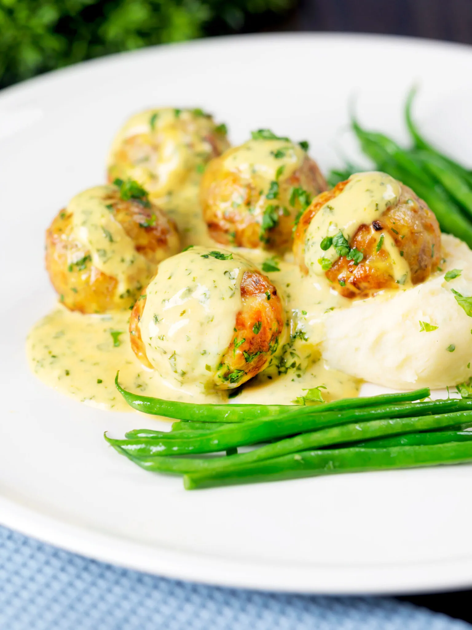 Chicken meatballs topped with honey mustard sauce. 