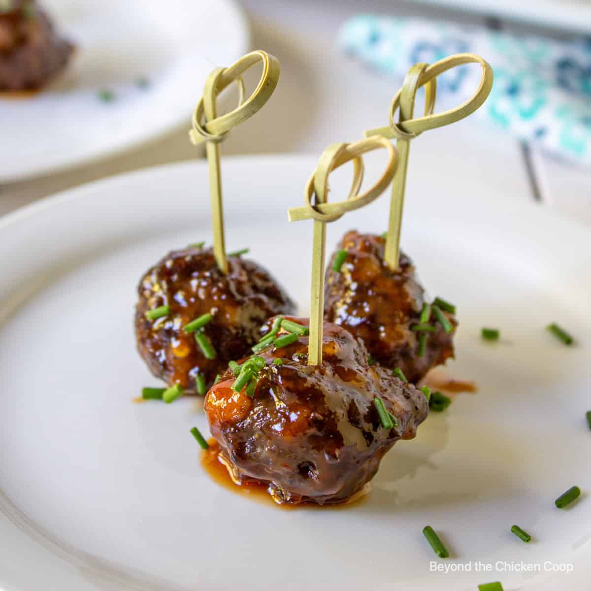 Toothpicks in cocktail meatballs on a plate. 