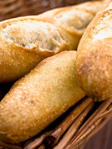Large french baguettes in a pile.