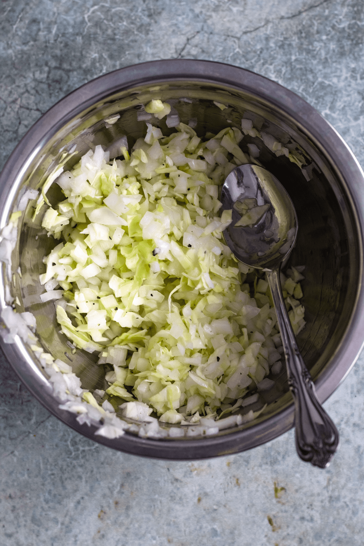 Vinegar soaked cabbage in a mixing bowl. 