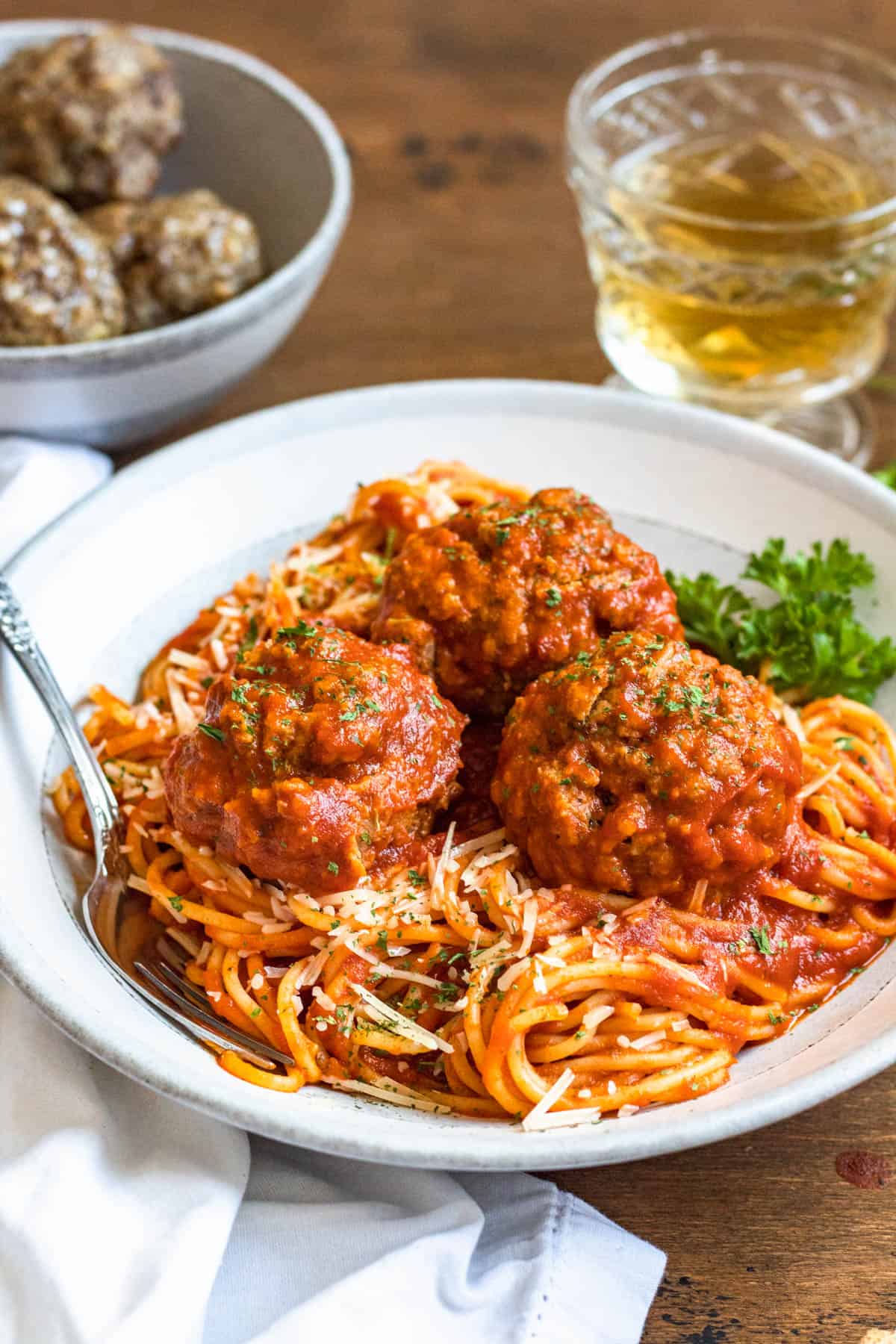 Soft meatballs served over a bed of spaghetti with sauce. 