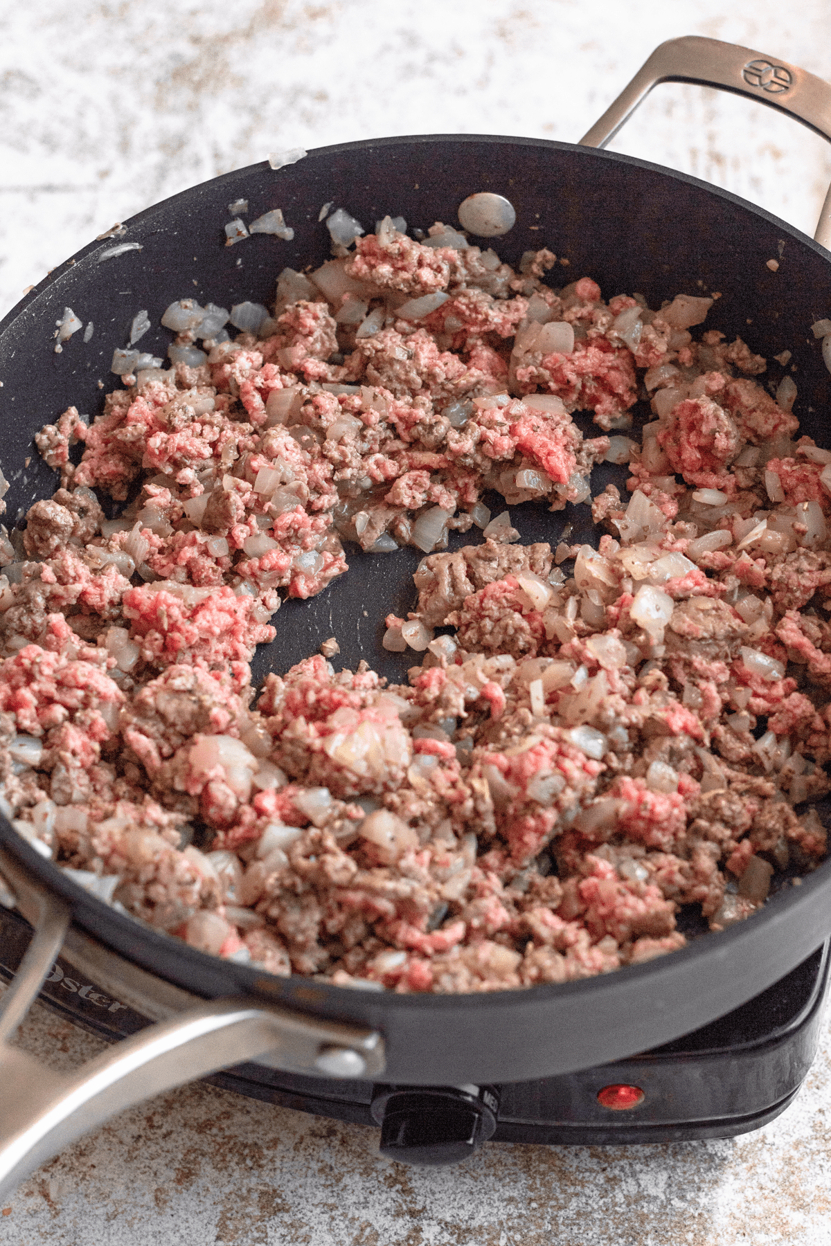 Ground beef and onions sauteing. 