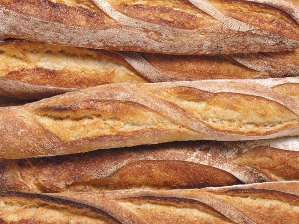 Several whole loaves of French bread. 