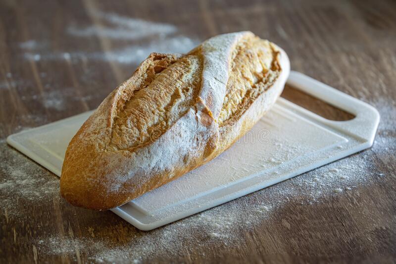 Italian loaf sitting on a cutting board. 