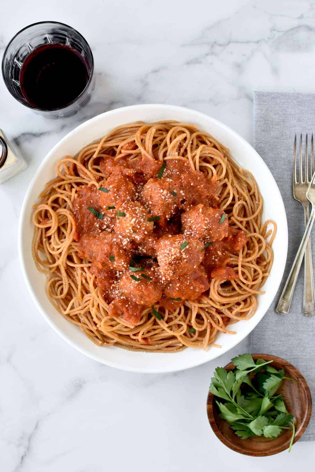 Instant pot turkey meatballs on a bed of spaghetti and covered with tomato sauce. 