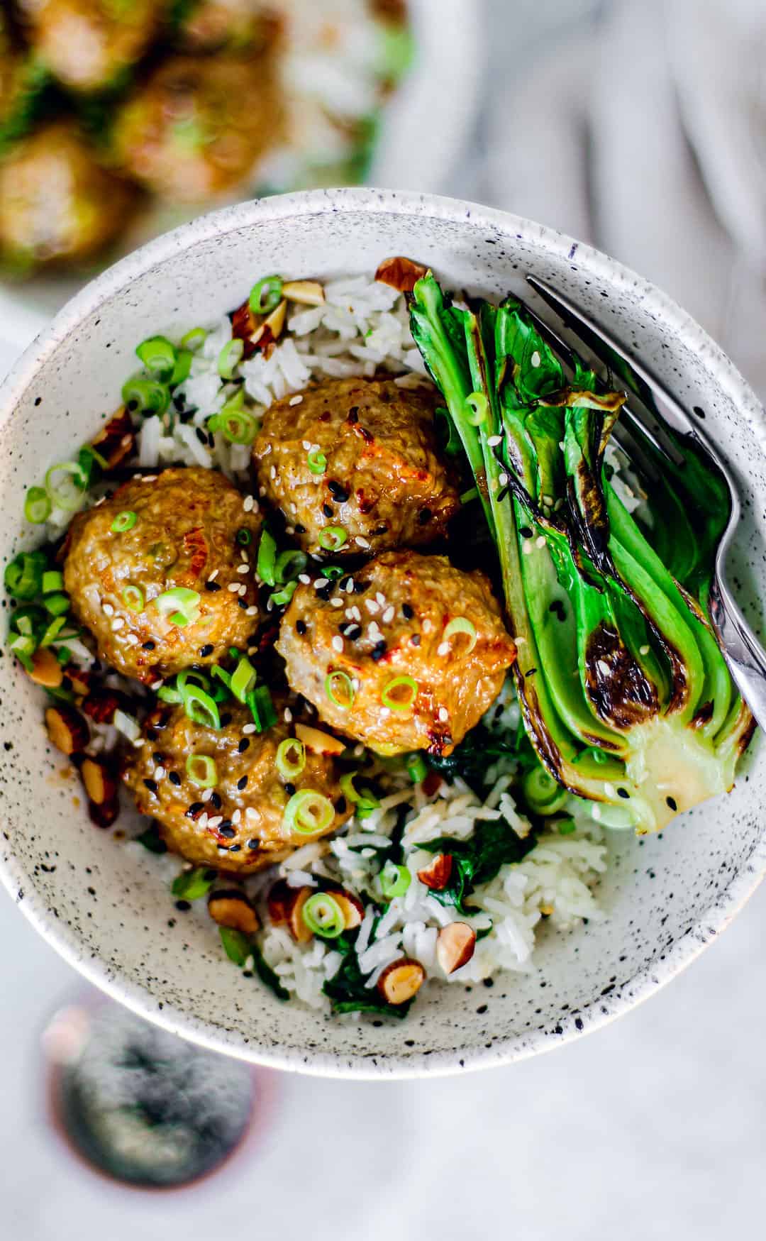 Garlic and ginger meatballs served over rice with a side of green veggies. 