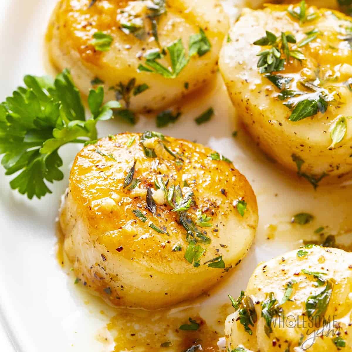Pan seared scallops with garlic sauce over the tops. 