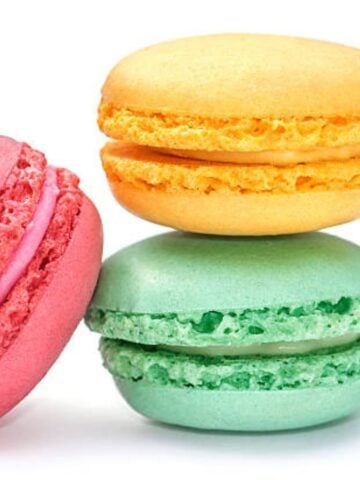 Different color macaron shells piled on top of each other.