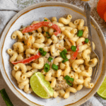 Pinterest image of a top view of a bowl of Jamaican Rasta Pasta with a fork on it.