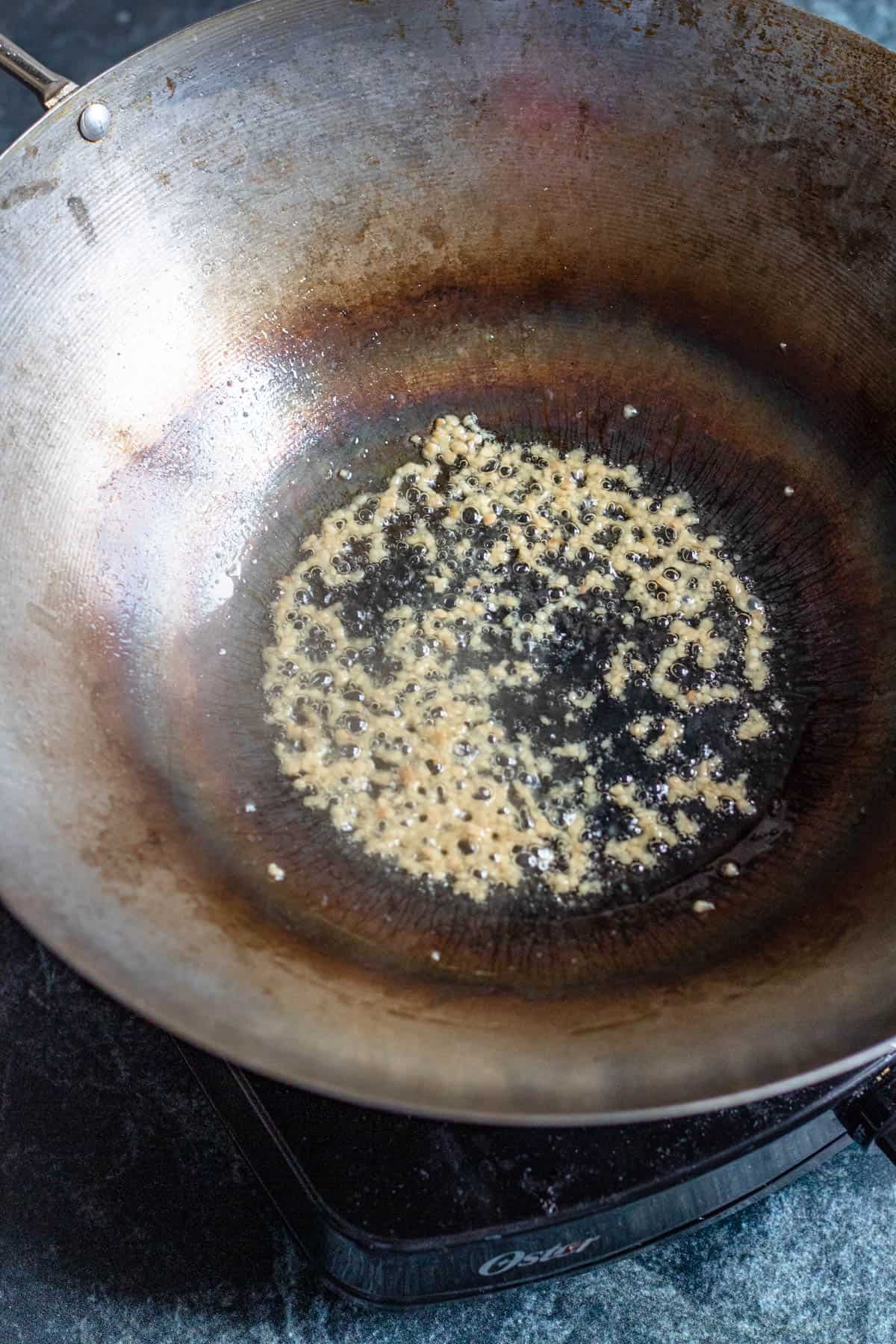 Garlic sauteing in a wok. 