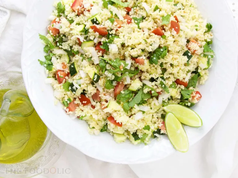 Citrus Couscous Salad in a bowl with lime wedges on the side. 