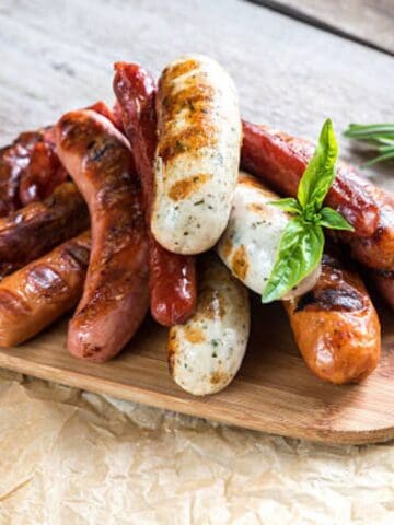 German sausages piled on top of a large serving platter.