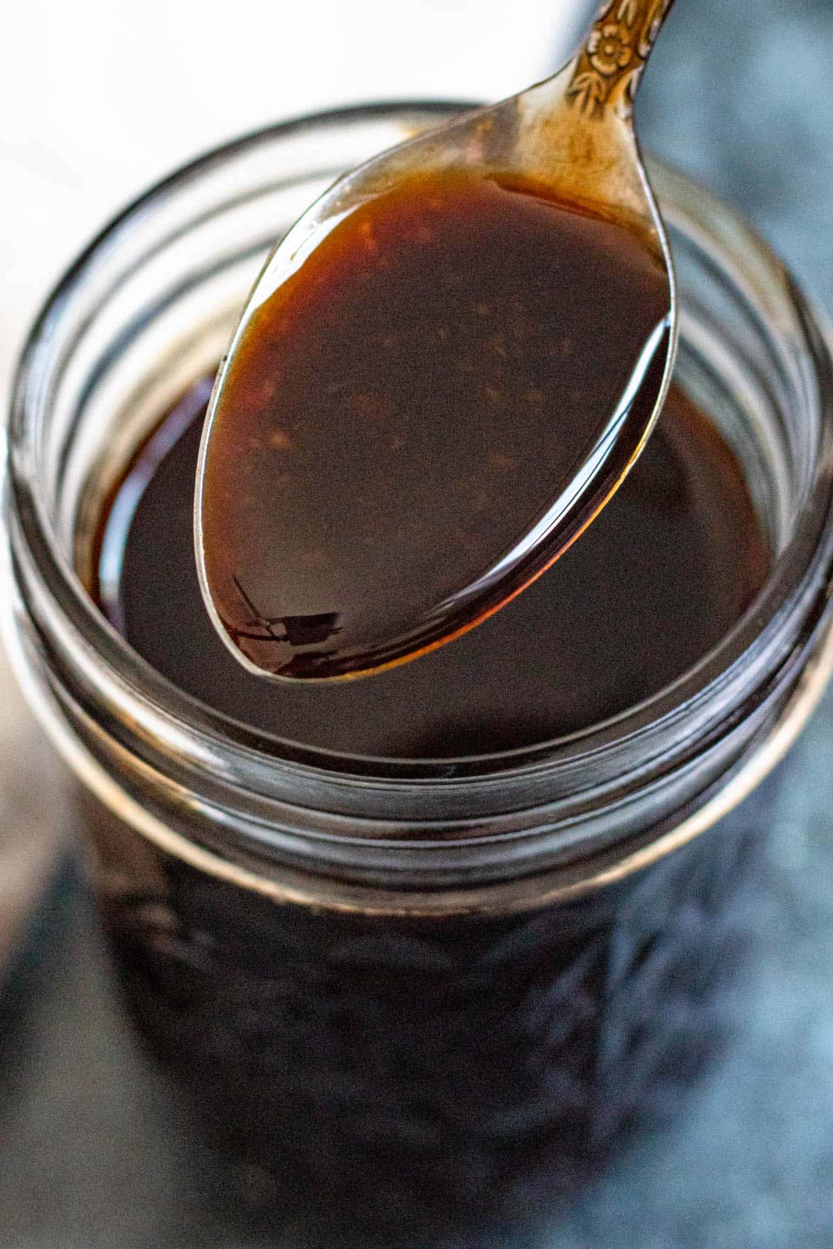 Spoonful of yakisoba sauce over a mason jar. 