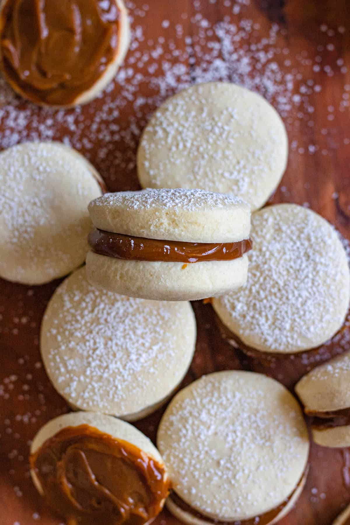 An alfajores argentinos laid on its side on top of another one to show the filling. 