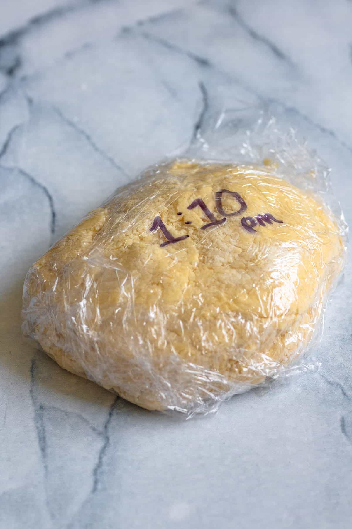 Alfajores Argentinos dough wrapped in plastic wrap. 