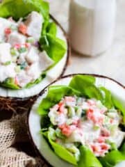 A large coconut lined with lettuce and then filled with ceviche in coconut milk.