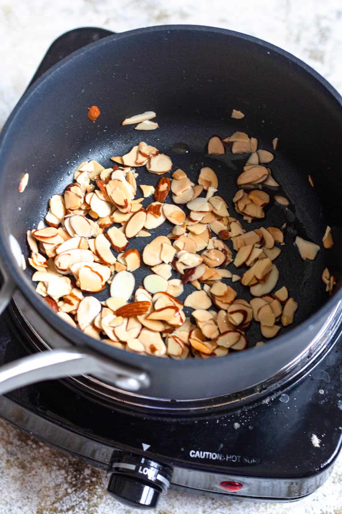 Toasted almonds in a saucepan. 