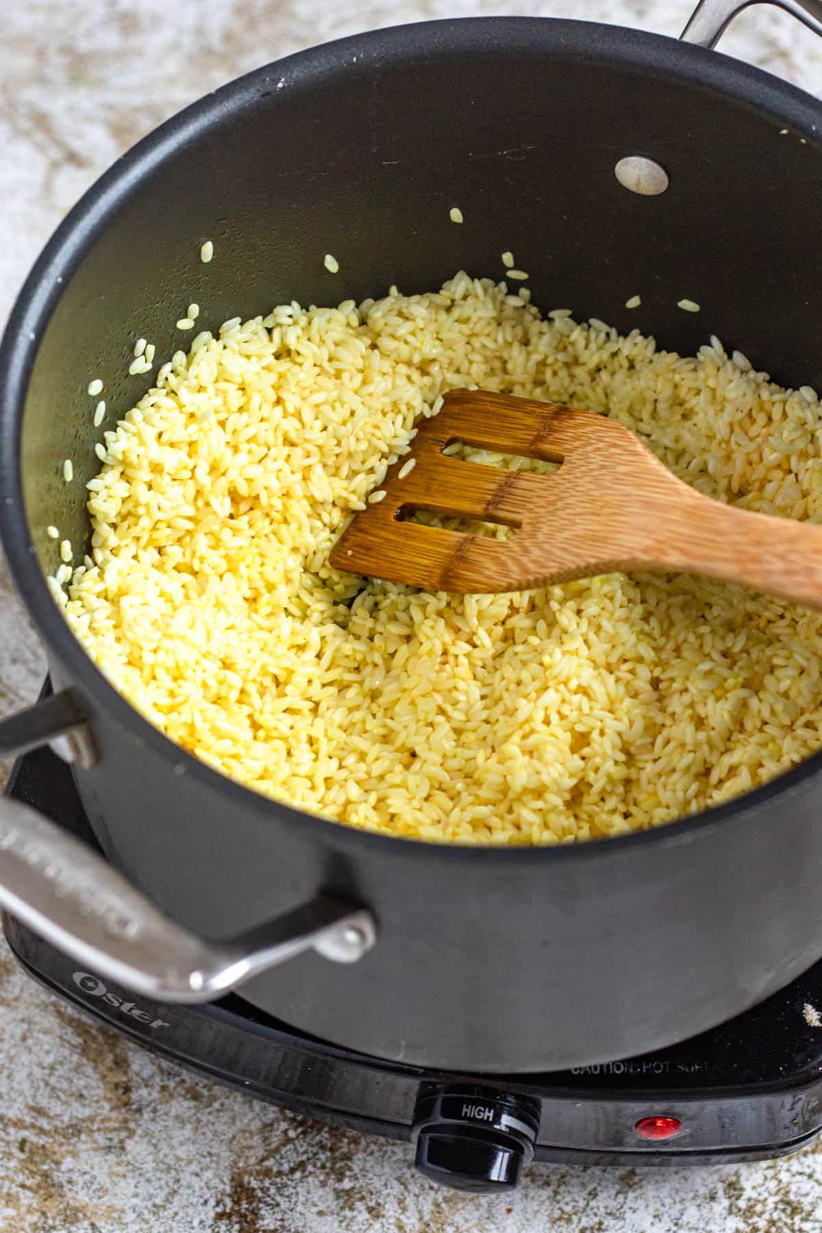 Uncooked rice seasoned in a saucepan. 