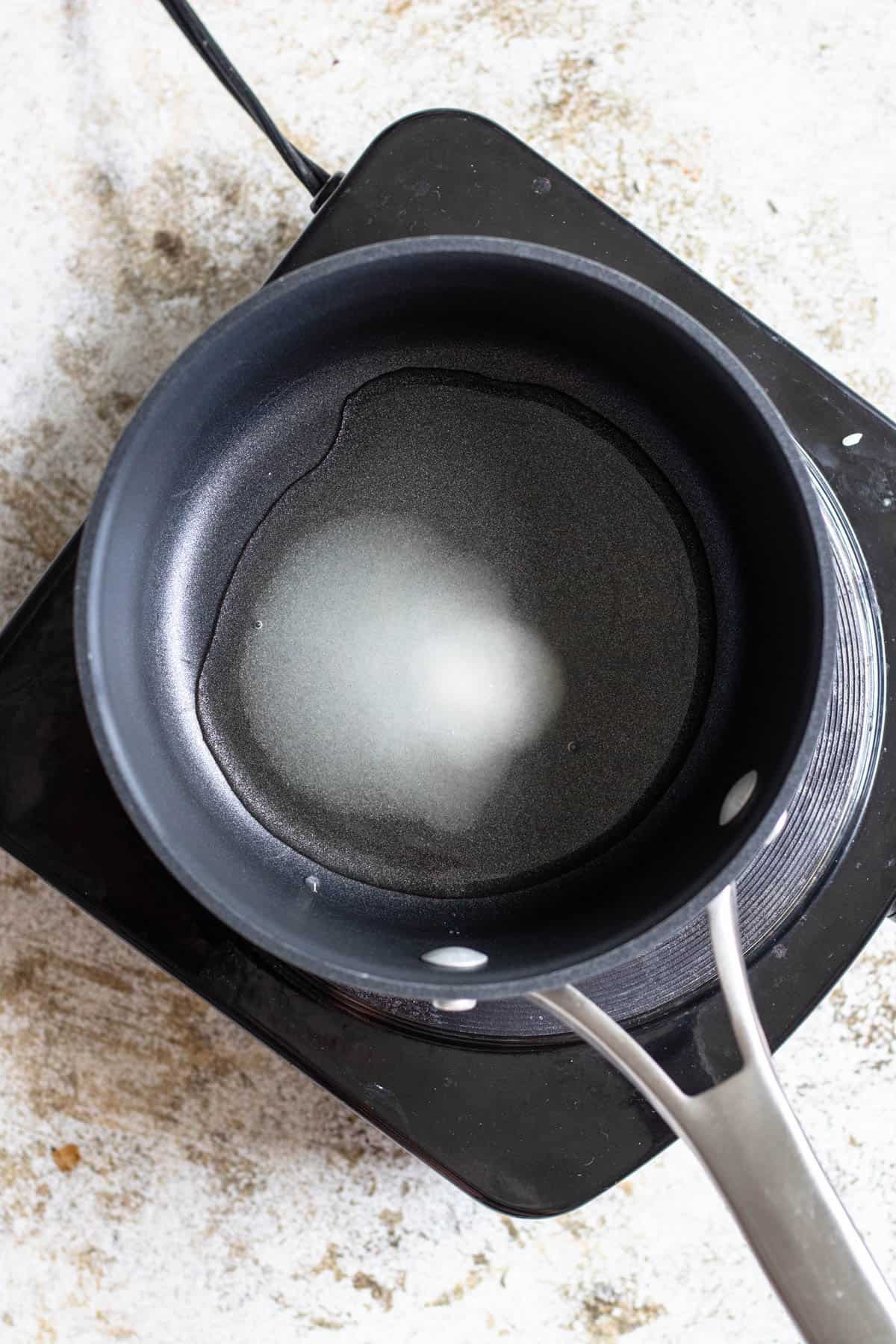 Rice vinegar, water and sugar in a saucepan. 