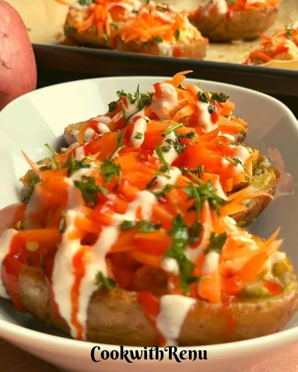 Baked potatoes topped with paneer and veggies. 