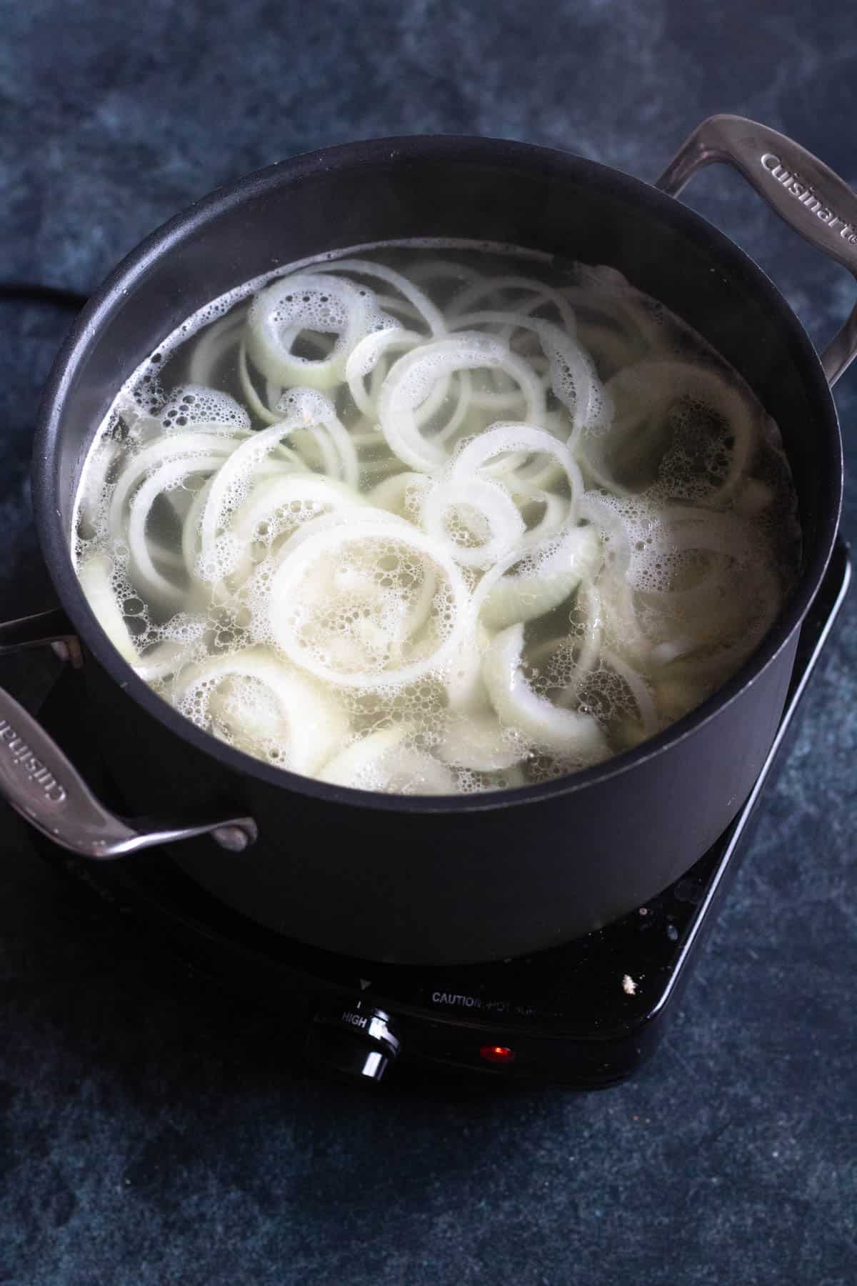 Onions simmering in a Dutch oven. 