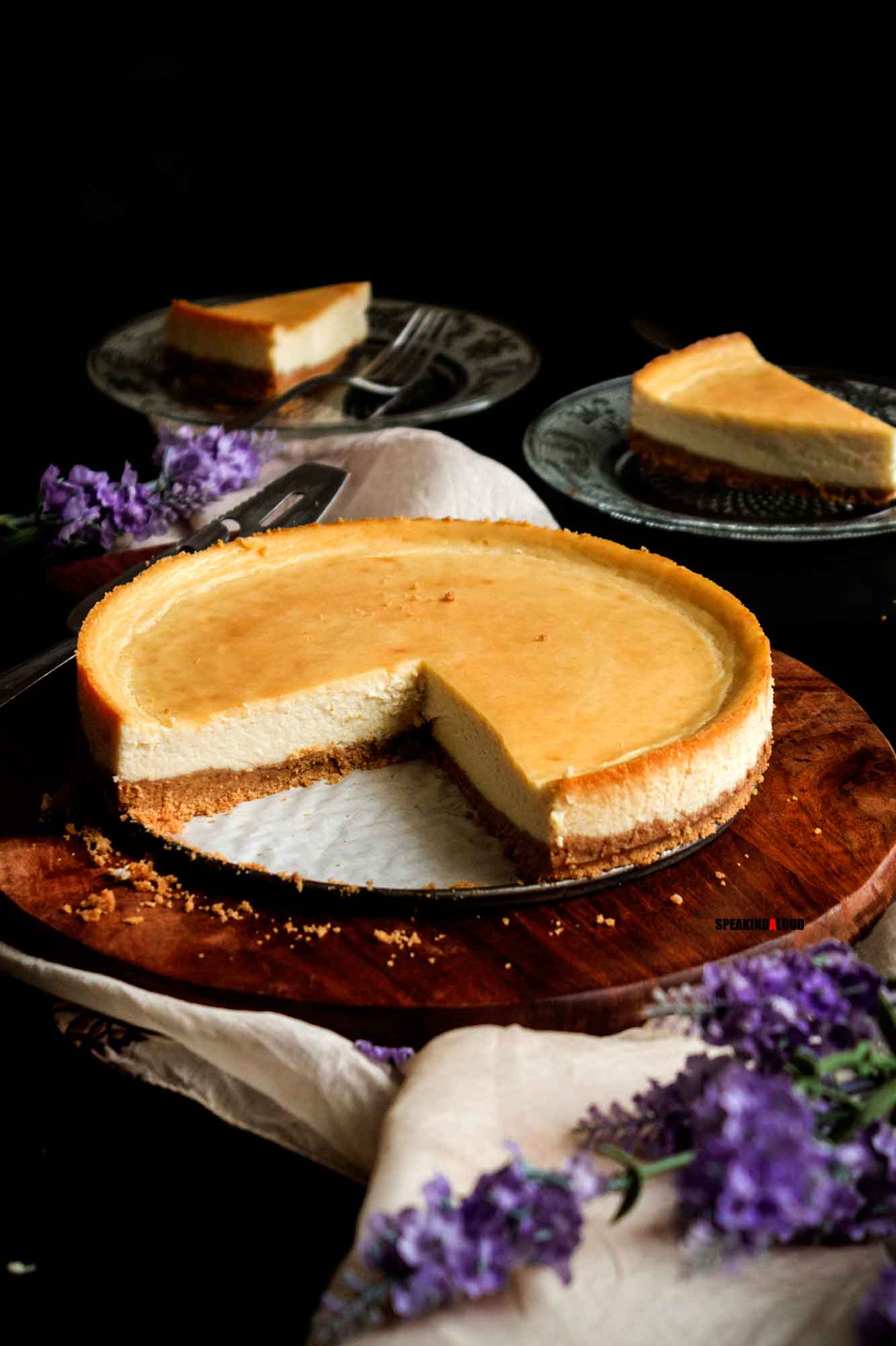 Cheesecake made without cream cheese with a couple of slices removed from the pan and served on plates. 