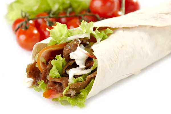 A doner kebab wrapped in a pide bread and topped wtih Turkish sauce, lettuce and tomatoes. 