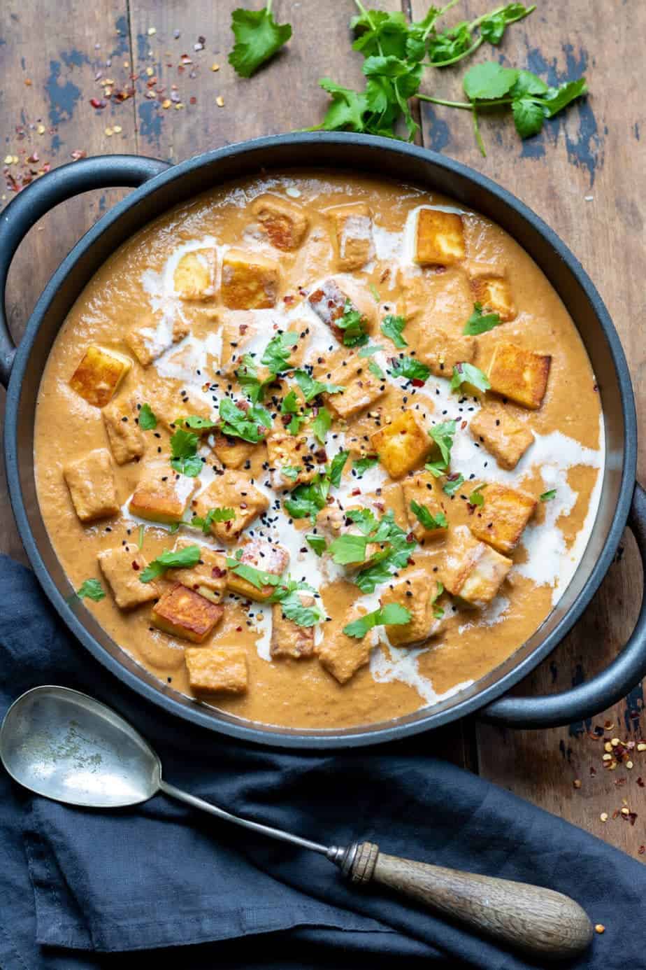 Paneer butter masala curry in a skillet. 
