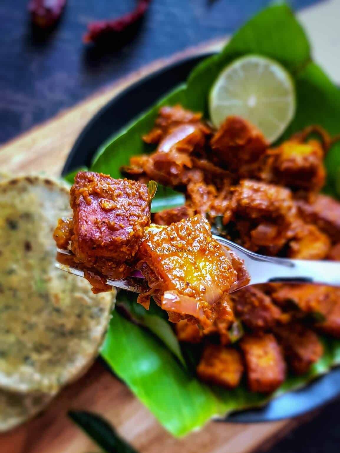 A forkful of paneer ghee roast. 