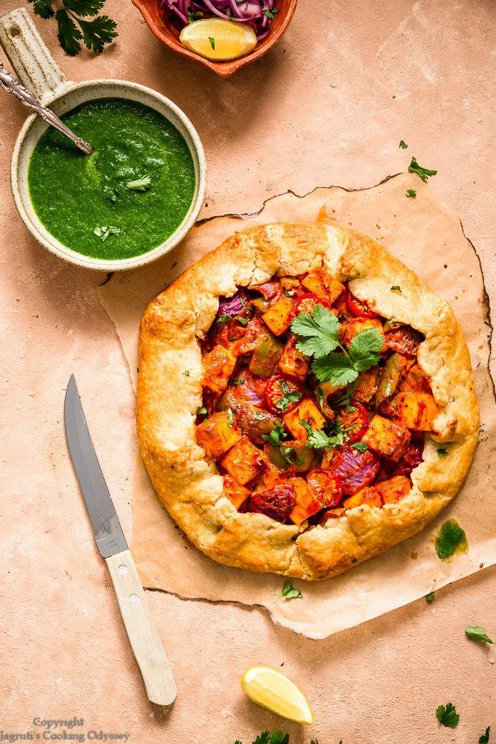 Tandoori Paneer Galette with a bowl of green sauce next to it. 
