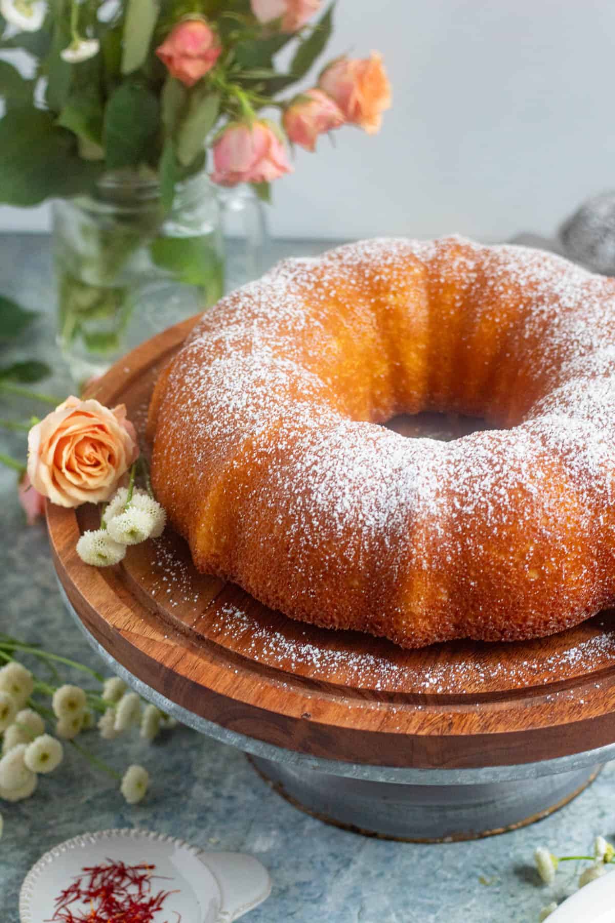 Powder sugar dusted over a cardamom cake or gers ogaily, sitting on a cake stand. 