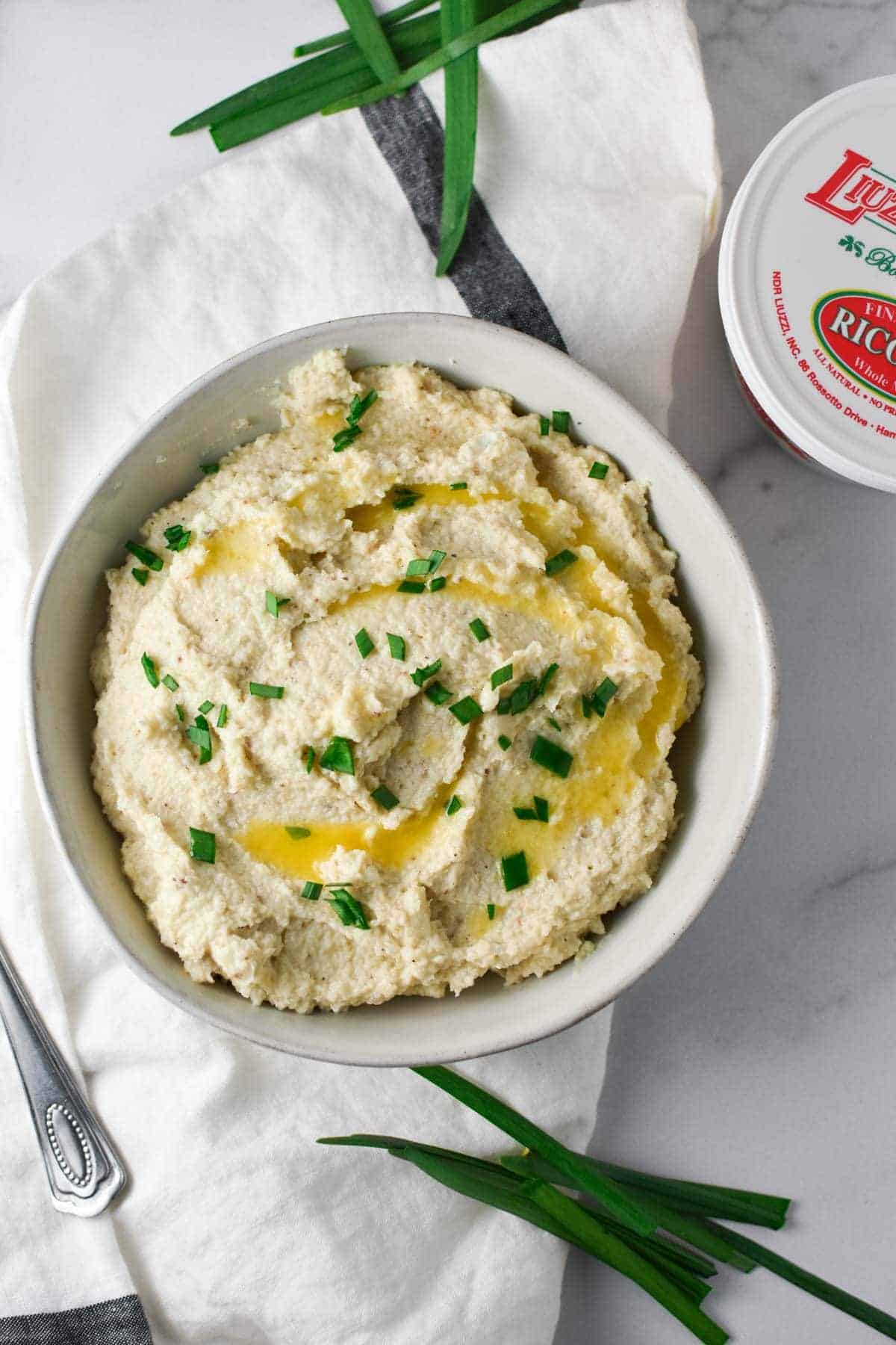 Roasted mashed cauliflower with chives garnished on top. 