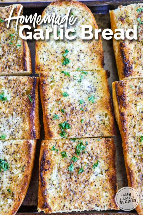 Garlic bread garnished with chopped parsley over the top, cut into squares. 