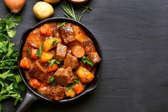 Personal size skillet of beef stew in a hearty sauce. 