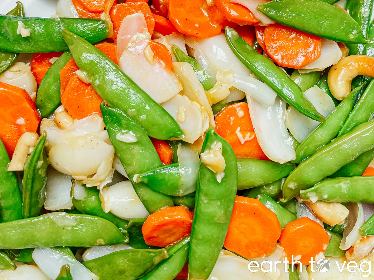 Stir fried Lily bulbs with cashews and snow peas close up. 