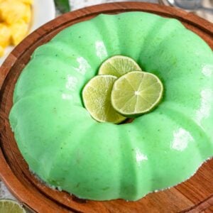 Lime Jello Salad on a large serving platter with lime slices in the center.