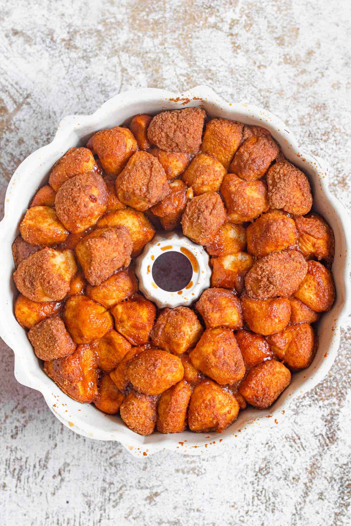 Freshly baked monkey bread in a bundt pan with caramelized cinnamon sugar a golden brown on the top. 